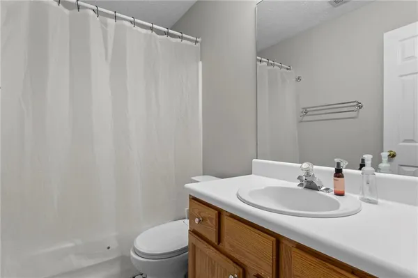 a bathroom with a sink toilet and a mirror