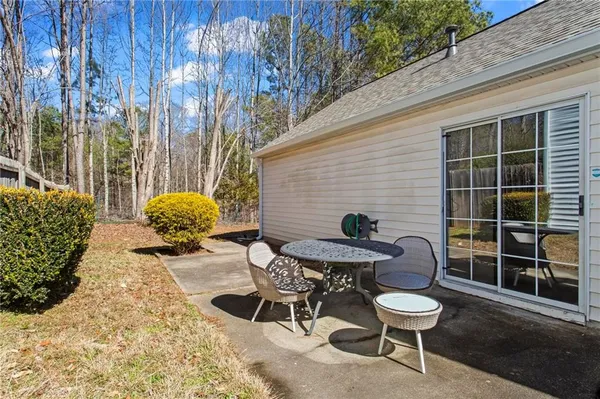 a backyard of a house with table and chairs