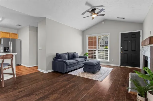 a living room with furniture ceiling fan and a window