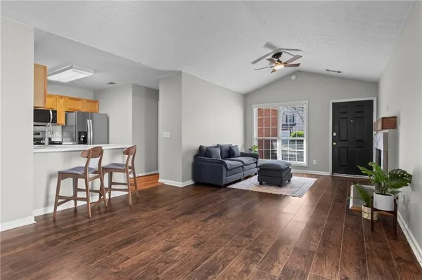 a living room with furniture and wooden floor
