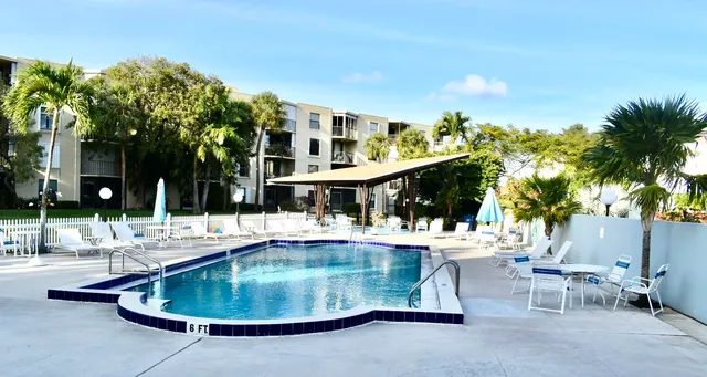 a swimming pool with outdoor seating and yard