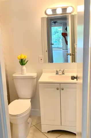 a bathroom with a sink mirror vanity and toilet