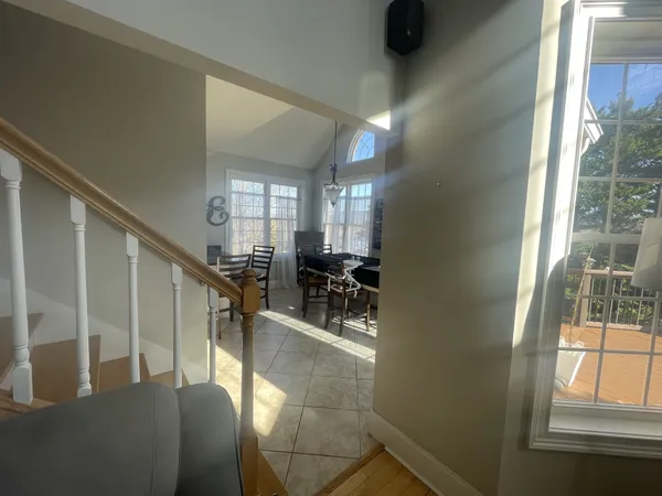 a kitchen with stainless steel appliances granite countertop a stove a sink a oven a dining table and chairs with wooden floor