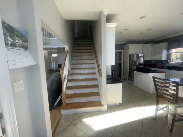 a large white kitchen with a sink and cabinets