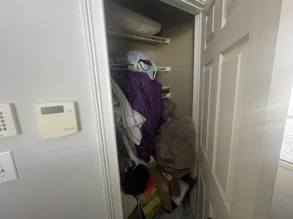 a view of walk in closet with clothes