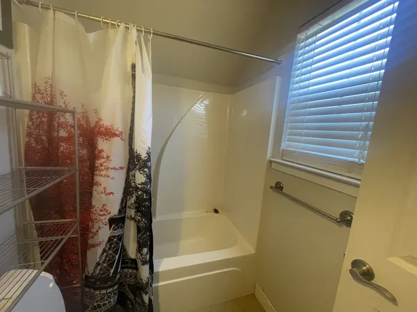 a bathroom with a toilet and a shower