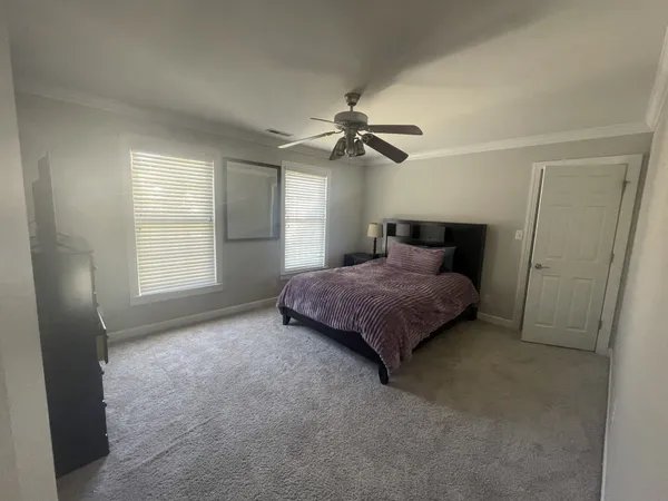 a room with furniture a flat screen tv and a floor to ceiling window