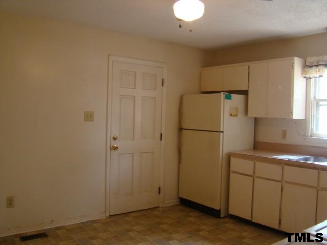 559 Dacian Road Raleigh, NC 27610 - Photo 8 of 12 a white refrigerator freezer sitting in a kitchen