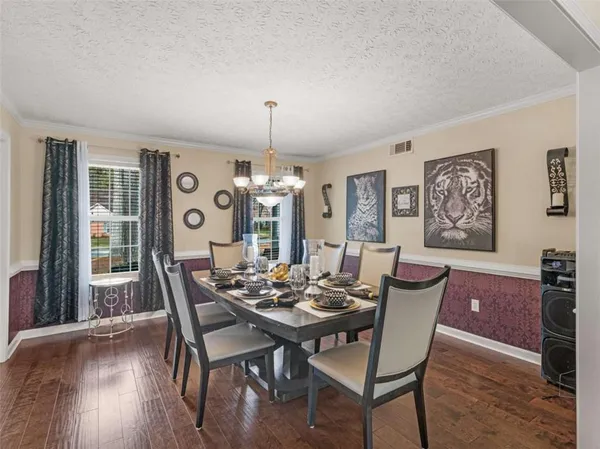 a view of a dining room with furniture wooden floor and chandelier