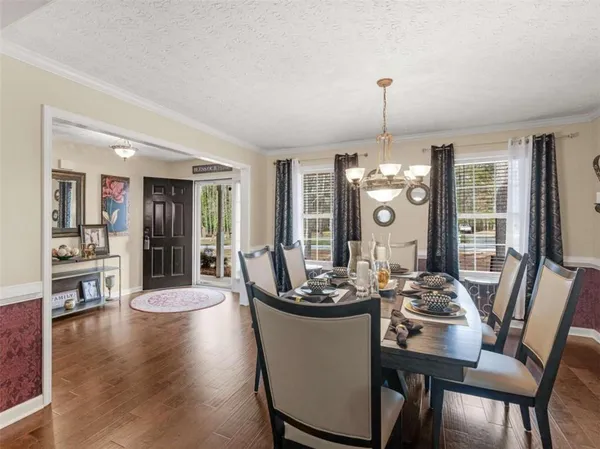 a dining room with furniture window and wooden floor