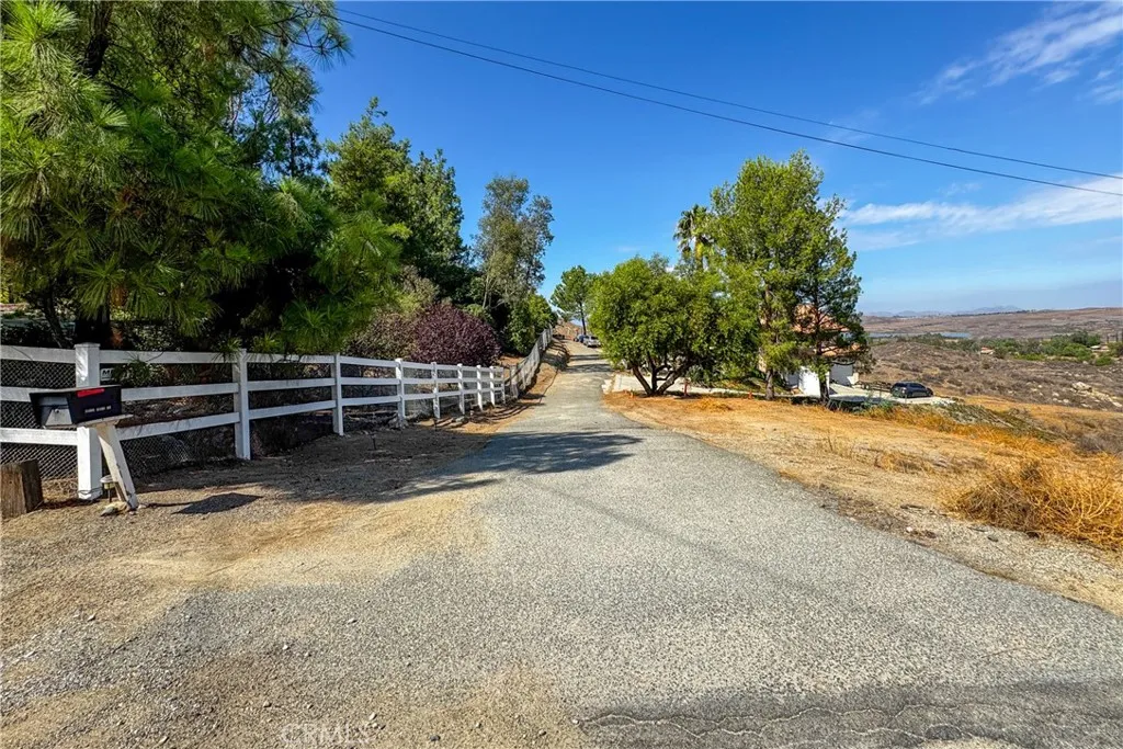 a view of backyard with wooden fence