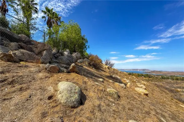 a view of a field with mountains in the background