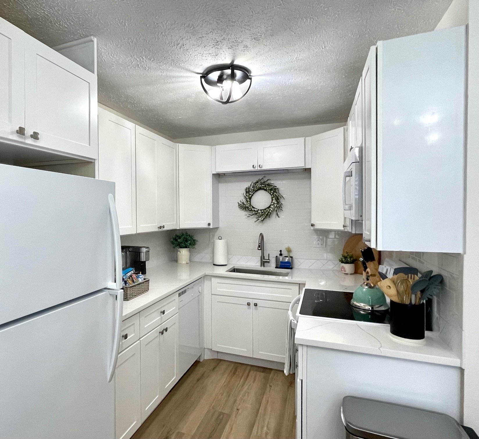 7526 Roundtree Avenue Murfreesboro, TN 37129 - Photo 37 of 67 a kitchen with a sink dishwasher a white refrigerator and cabinets with wooden floor