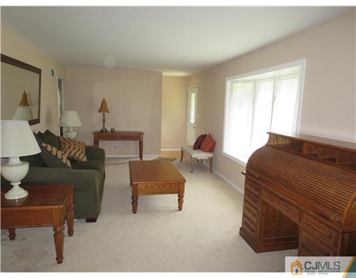5 Maida Road Edison, NJ 08820 - Photo 2 of 23 a bedroom with furniture and a lamp