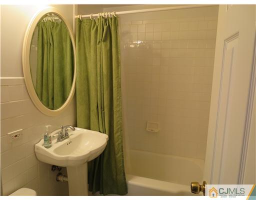 5 Maida Road Edison, NJ 08820 - Photo 16 of 23 a bathroom with a sink a mirror and a shower