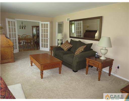 5 Maida Road Edison, NJ 08820 - Photo 3 of 23 a living room with furniture and a potted plant
