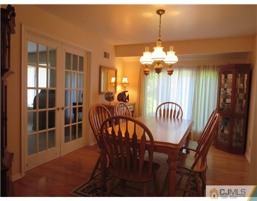 5 Maida Road Edison, NJ 08820 - Photo 5 of 23 a dining room with furniture a chandelier and wooden floor