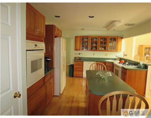 5 Maida Road Edison, NJ 08820 - Photo 6 of 23 a kitchen with stainless steel appliances granite countertop a refrigerator a stove and a wooden cabinets