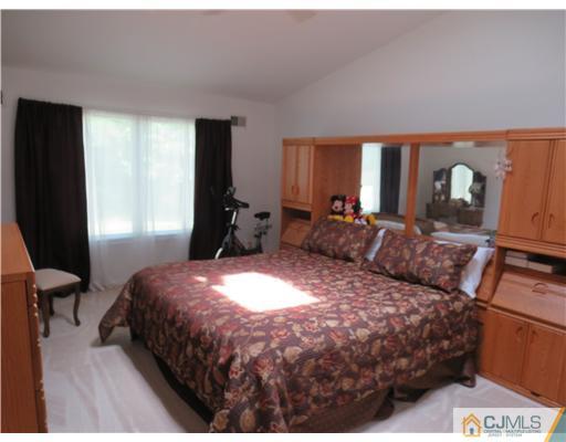 5 Maida Road Edison, NJ 08820 - Photo 10 of 23 a bedroom with a bed mirror and window