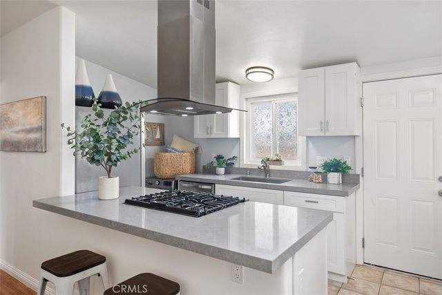 a dining room with furniture and a large window
