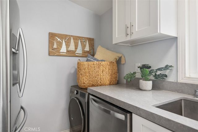 a kitchen with stainless steel appliances granite countertop a sink a stove and a refrigerator