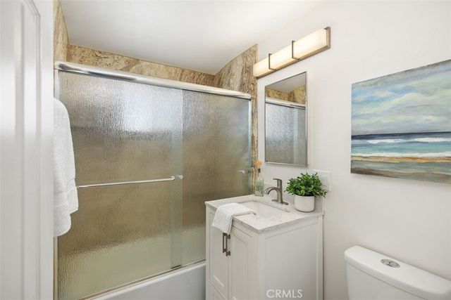 a kitchen with a refrigerator and cabinets