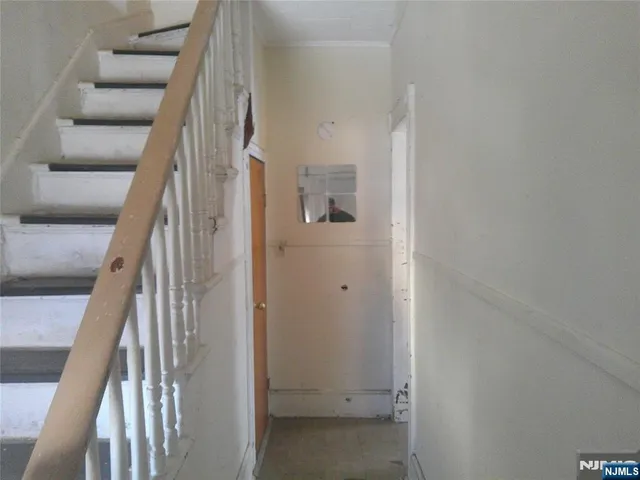 a view of staircase with white walls