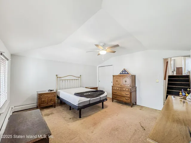 a bathroom with a toilet sink vanity and mirror