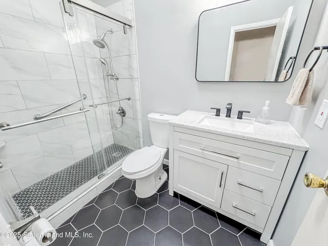 a bedroom with a bed wooden floor and lamp