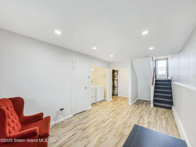 a view of washer and dryer with bathroom in the background