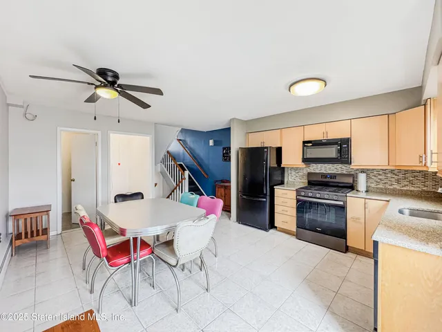 a kitchen with stainless steel appliances kitchen island granite countertop a sink and cabinets