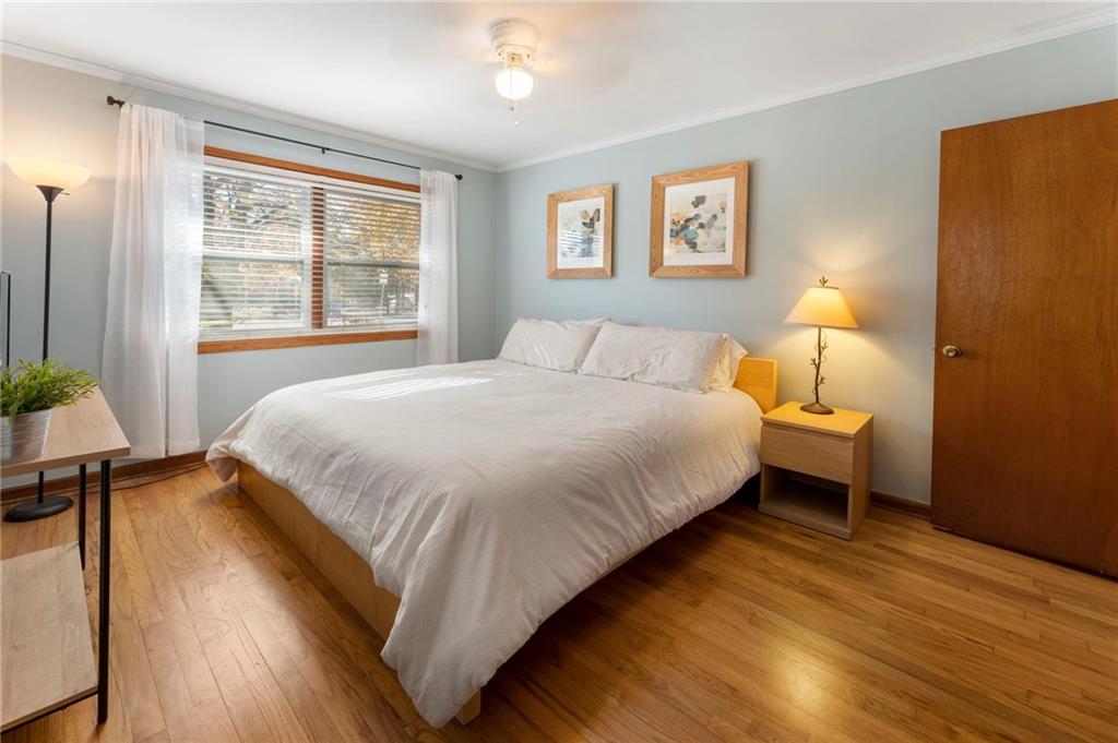 5122 Lavista Road Tucker, GA 30084 - Photo 17 of 24 a bedroom with a bed and wooden floor