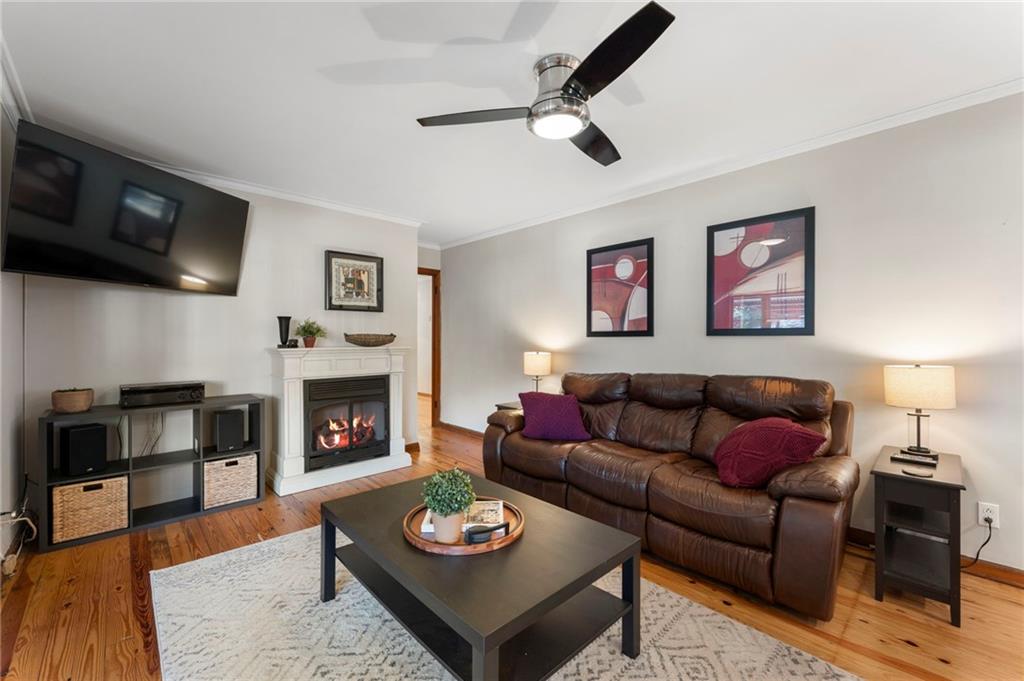 5122 Lavista Road Tucker, GA 30084 - Photo 2 of 24 a living room with furniture a fireplace and a flat screen tv