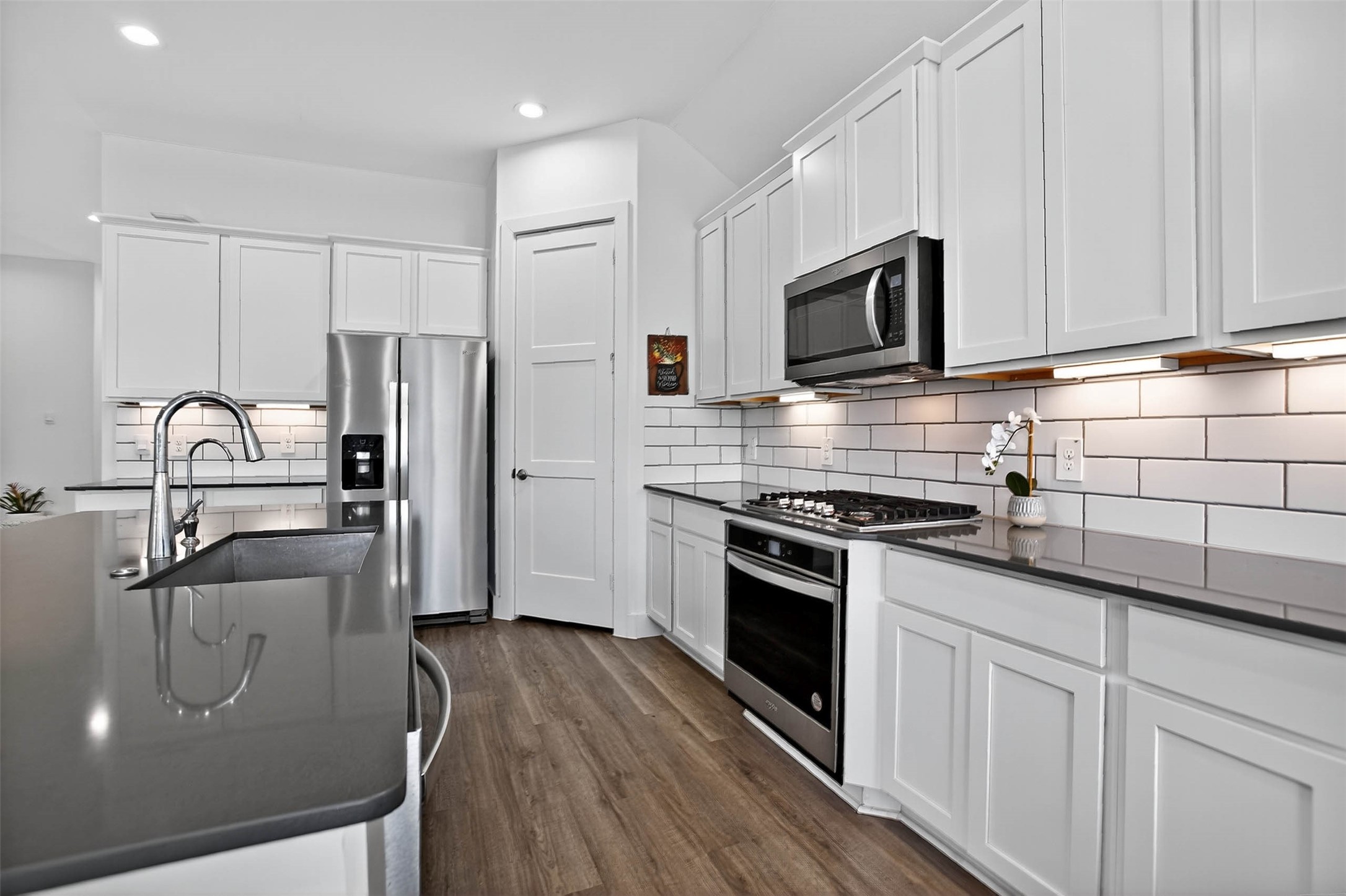 13760 Rising Sun Lane Conroe, TX 77384 - Photo 14 of 43 a kitchen with stainless steel appliances granite countertop a refrigerator sink and microwave
