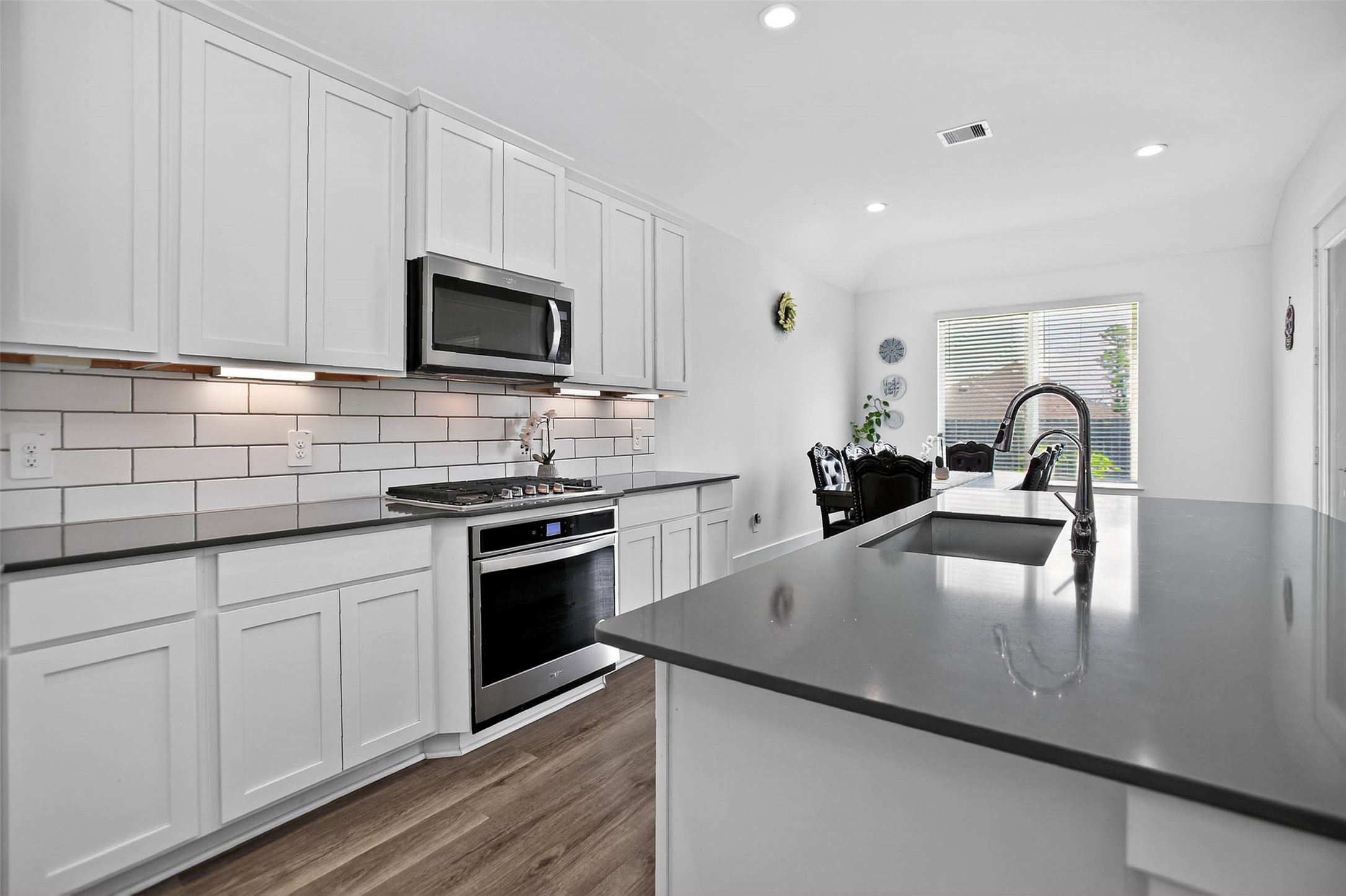 13760 Rising Sun Lane Conroe, TX 77384 - Photo 15 of 43 a kitchen with stainless steel appliances granite countertop a sink a stove top oven a counter space and cabinets