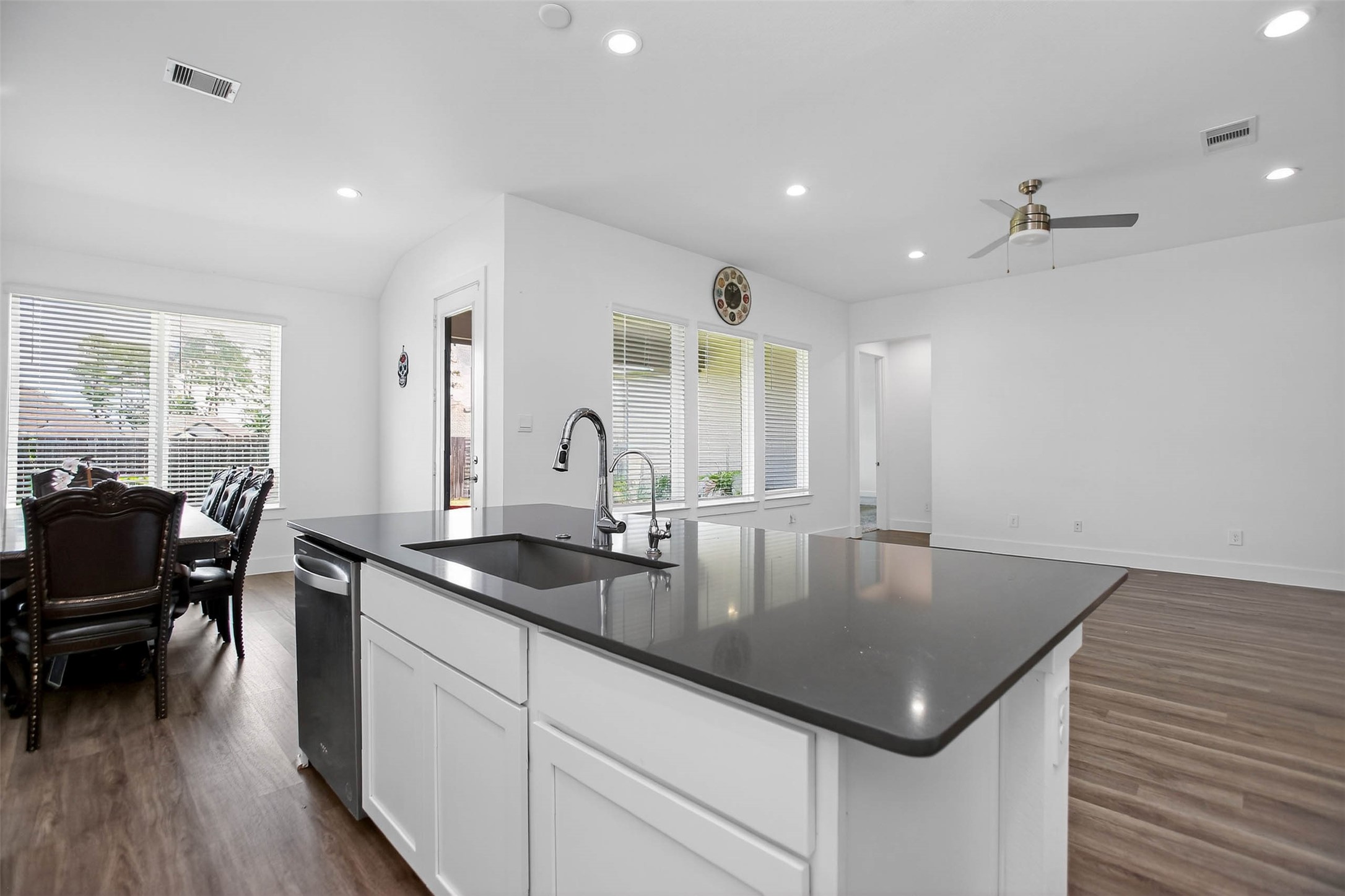 13760 Rising Sun Lane Conroe, TX 77384 - Photo 17 of 43 a kitchen with a sink a counter top space and living room view
