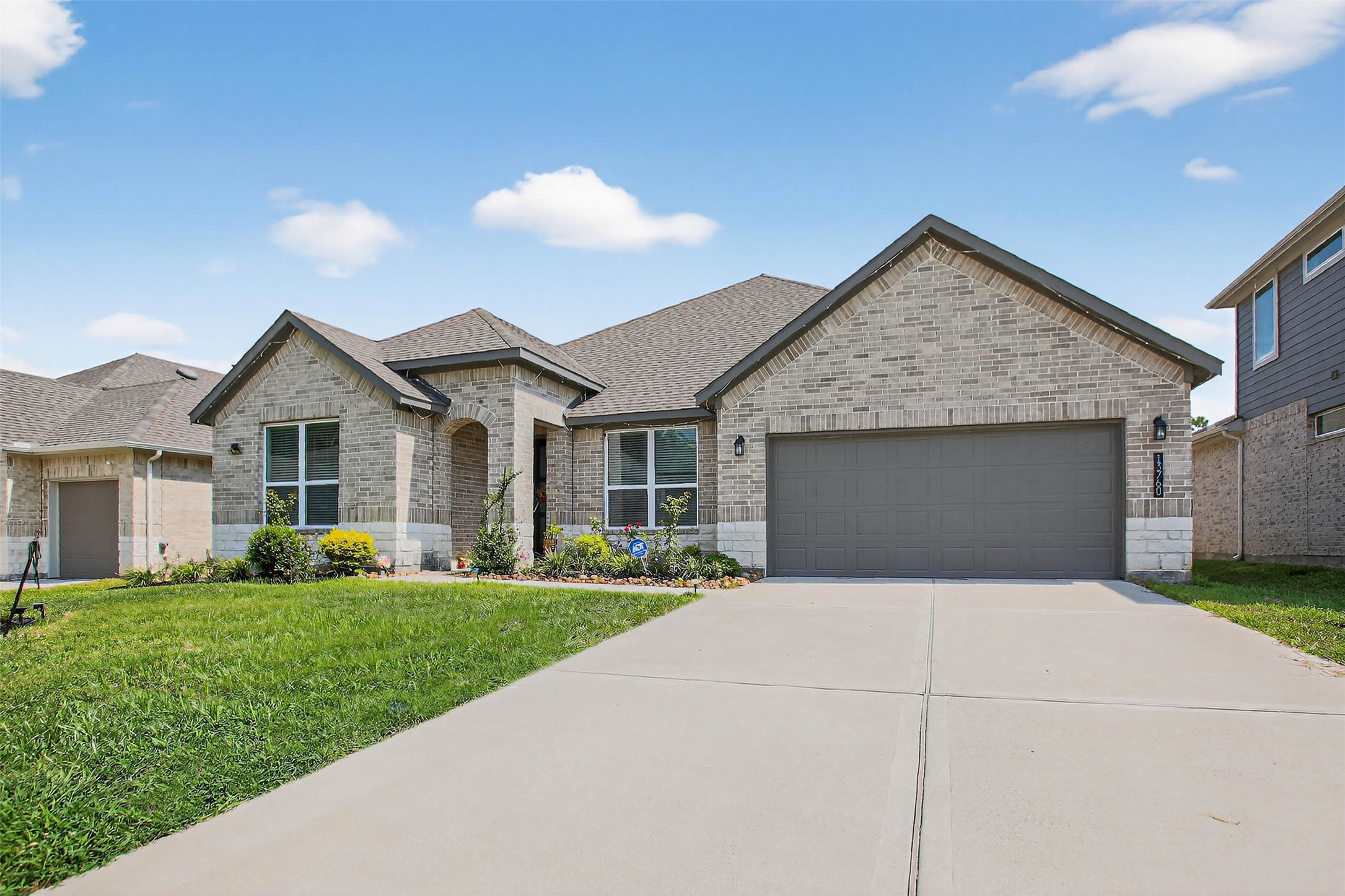 13760 Rising Sun Lane Conroe, TX 77384 - Photo 2 of 43 a front view of a house with a yard and trees