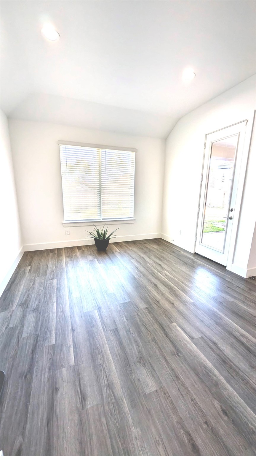 13760 Rising Sun Lane Conroe, TX 77384 - Photo 24 of 43 an empty room with wooden floor and windows