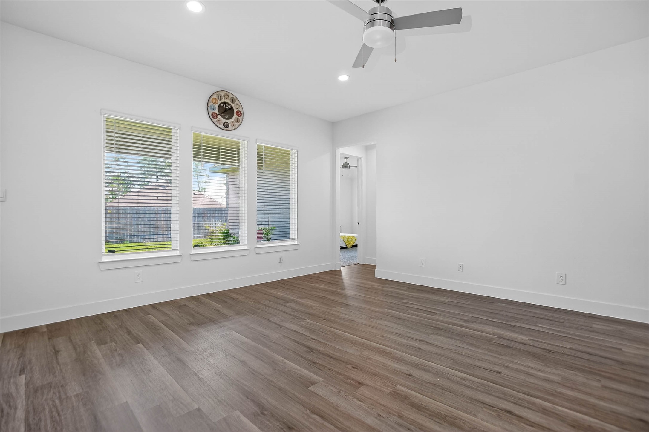 13760 Rising Sun Lane Conroe, TX 77384 - Photo 26 of 43 an empty room with wooden floor and windows