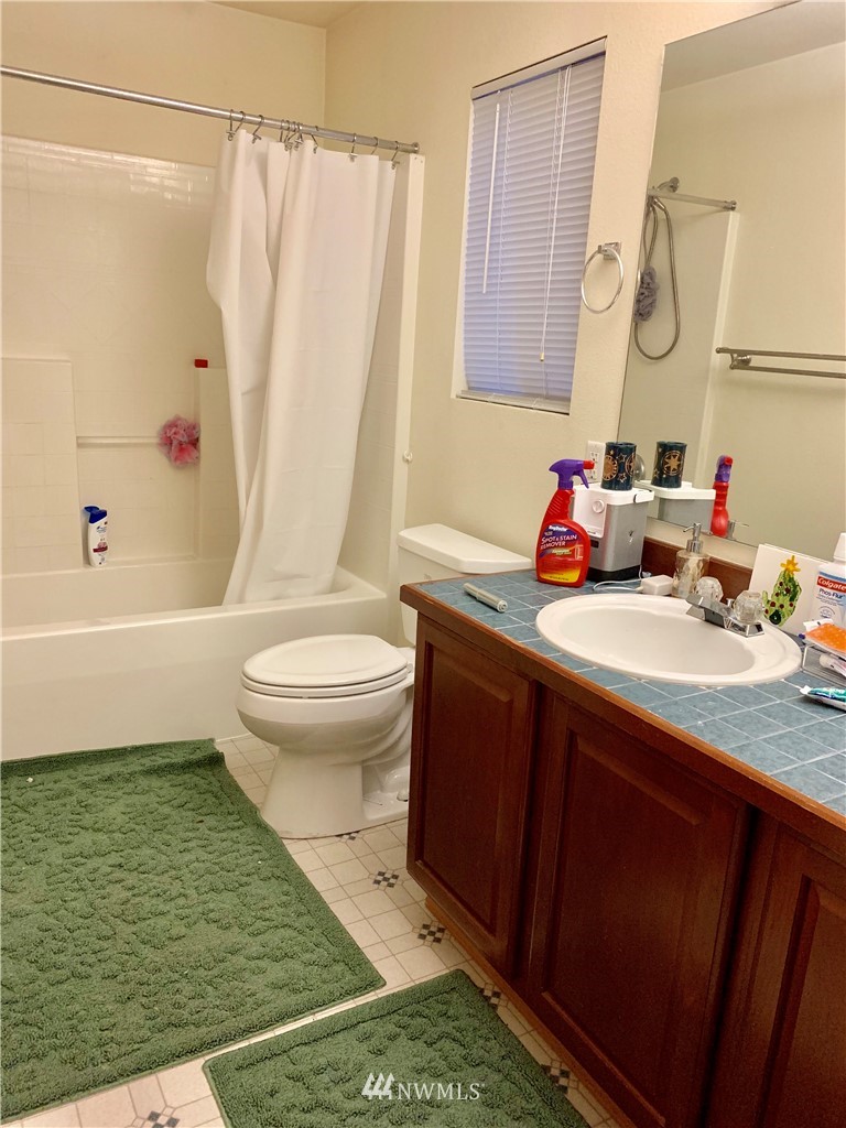 2969 South 296th Street Federal Way, WA 98003 - Photo 4 of 5 a bathroom with a sink a toilet and shower curtain