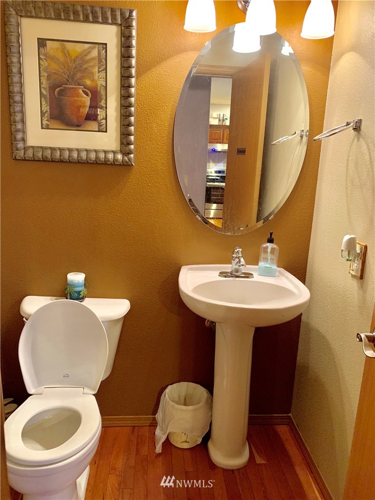 2969 South 296th Street Federal Way, WA 98003 - Photo 5 of 5 a bathroom with a toilet a sink and mirror