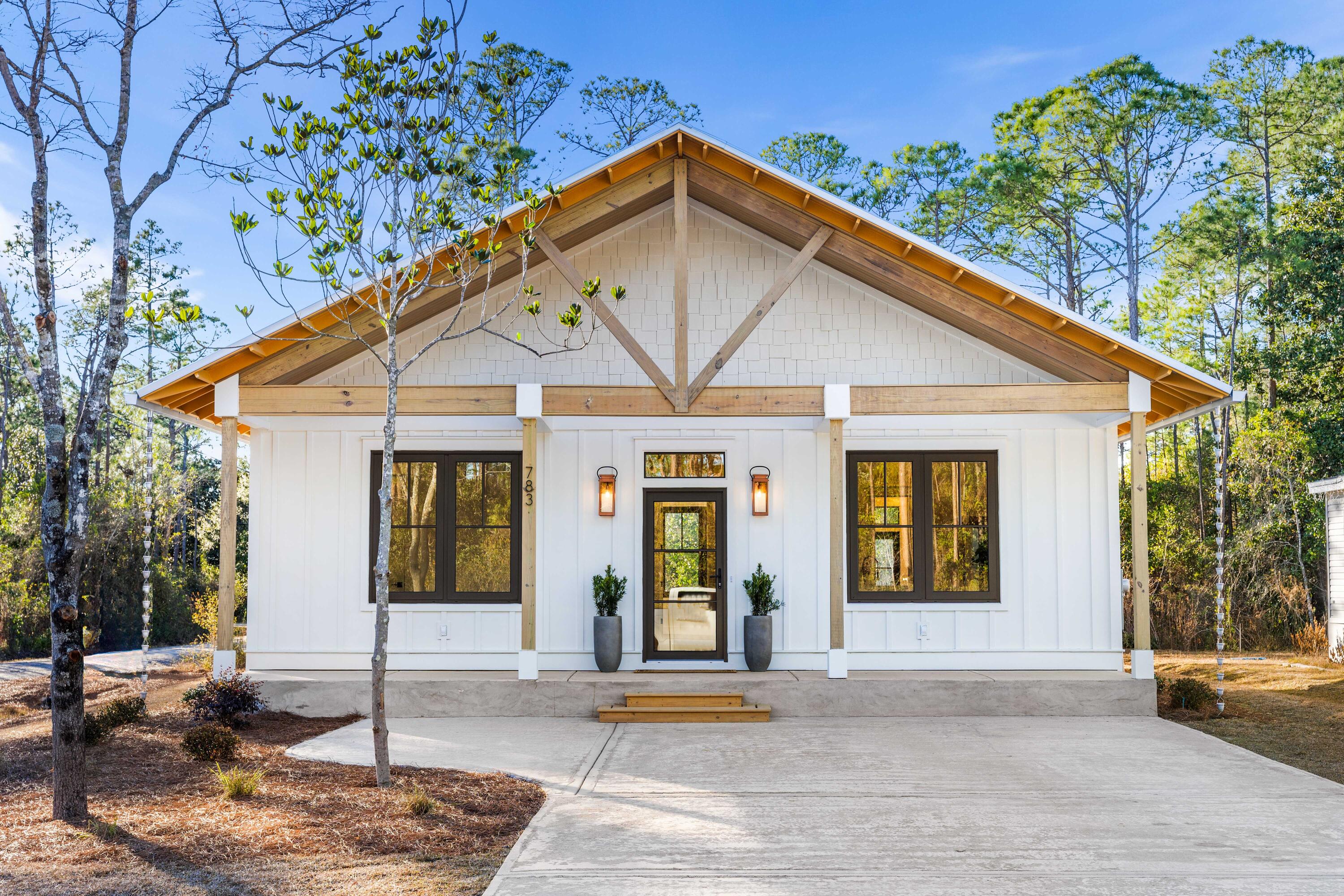 783 Indian Woman Road Santa Rosa Beach, FL 32459 - Photo 1 of 33 a front view of a house with garden