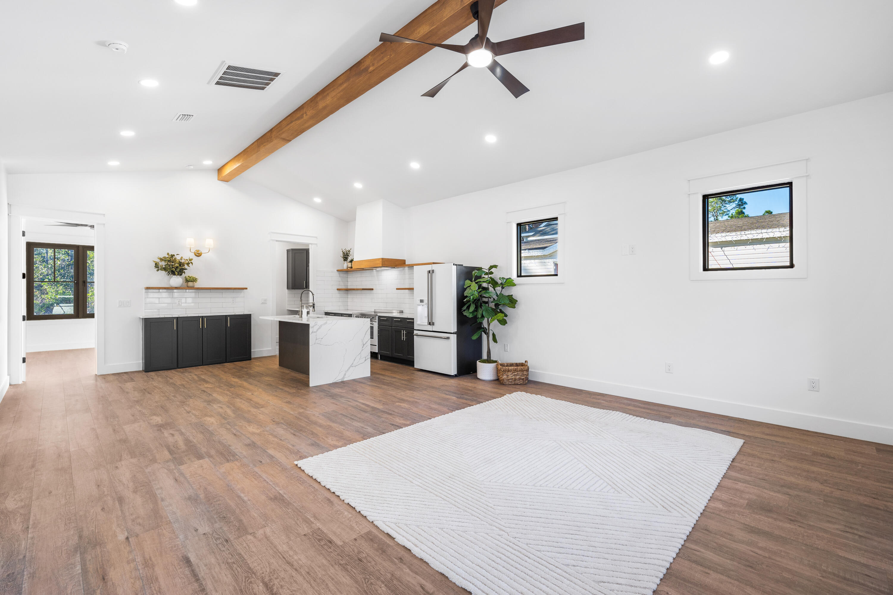 783 Indian Woman Road Santa Rosa Beach, FL 32459 - Photo 12 of 33 a big room with wooden floor and kitchen view