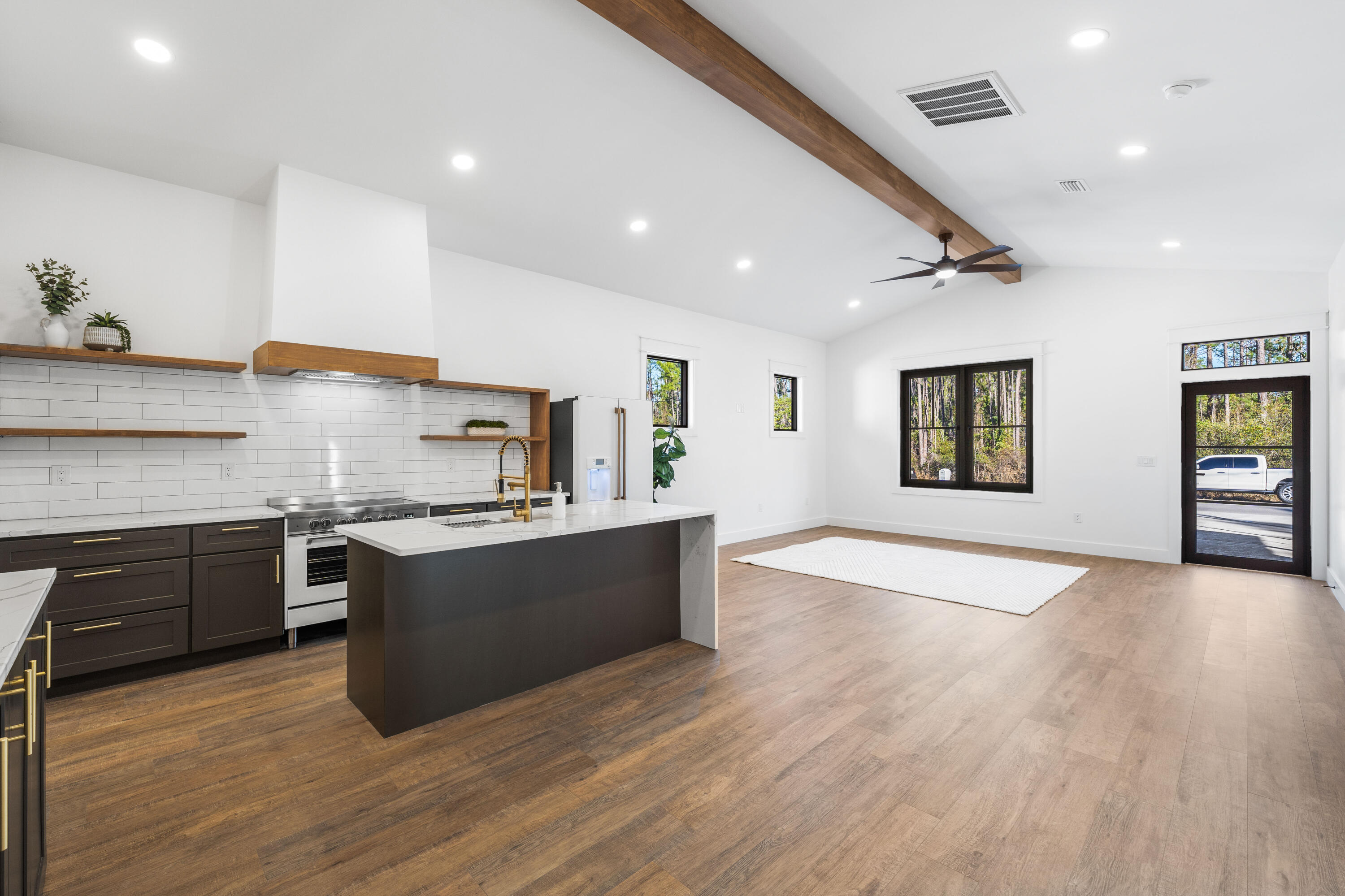 783 Indian Woman Road Santa Rosa Beach, FL 32459 - Photo 16 of 33 a large kitchen with stainless steel appliances granite countertop a stove and a wooden floors