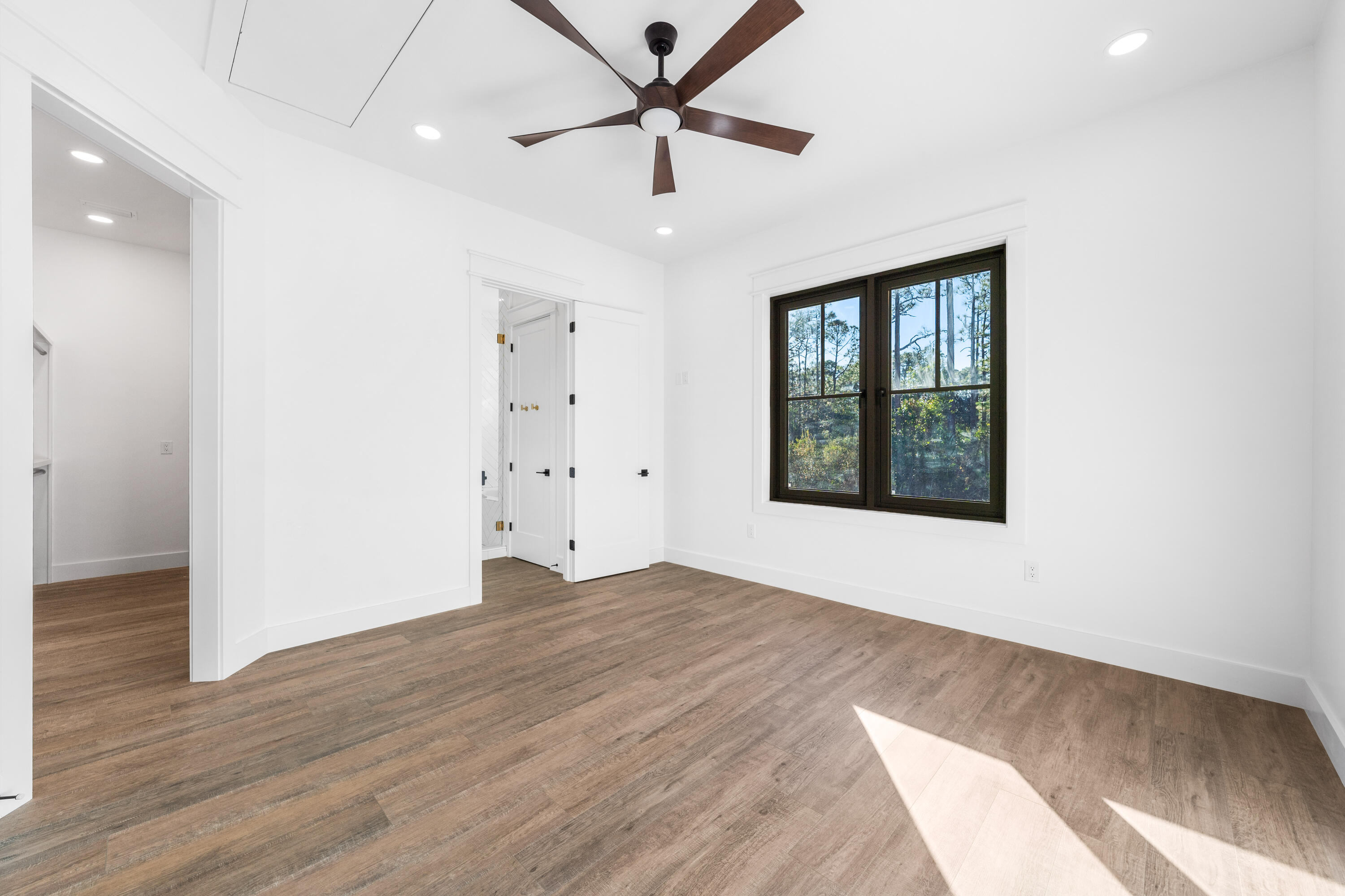 783 Indian Woman Road Santa Rosa Beach, FL 32459 - Photo 17 of 33 wooden floor in an empty room with a window