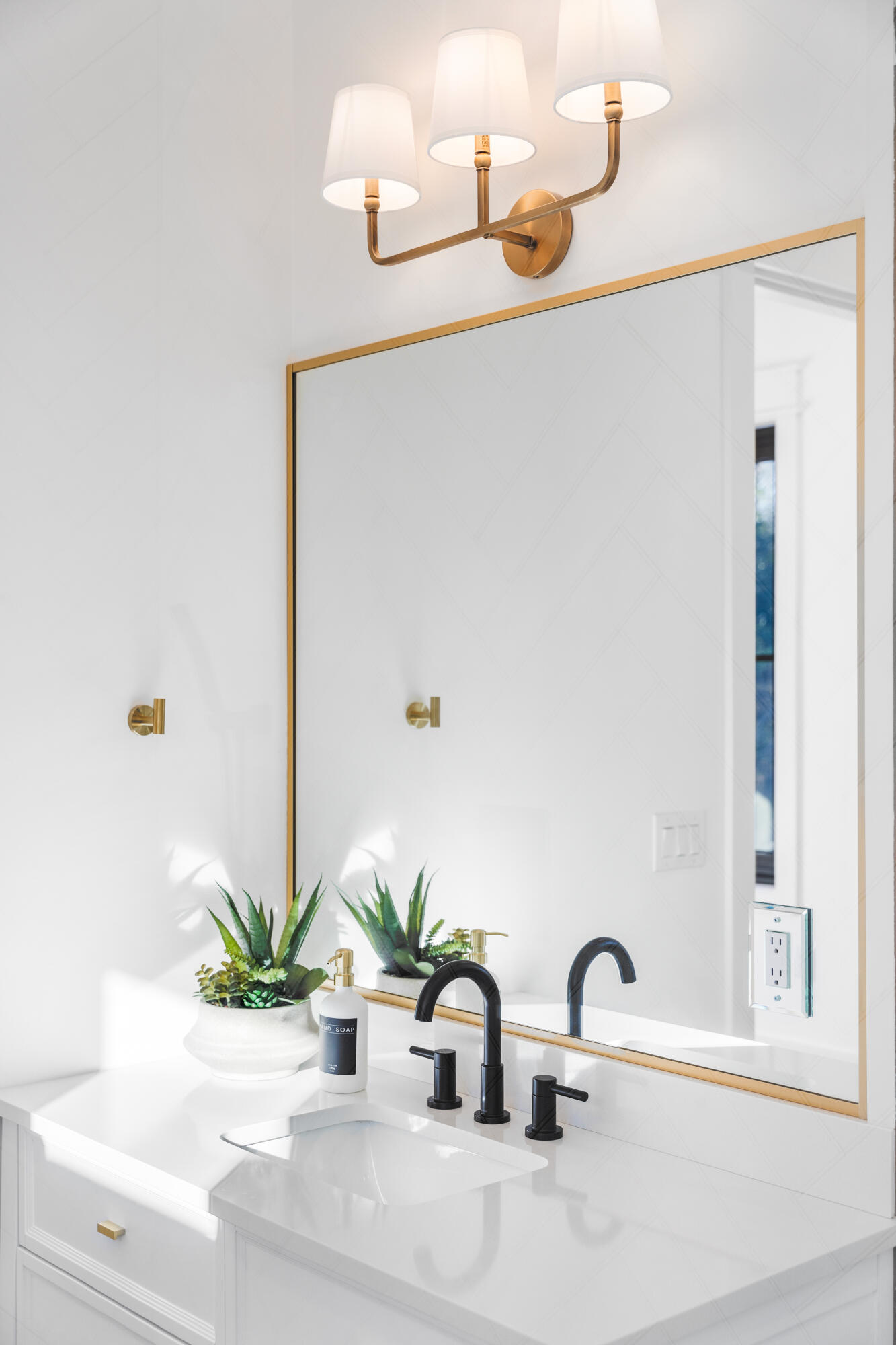783 Indian Woman Road Santa Rosa Beach, FL 32459 - Photo 23 of 33 a bathroom with a sink a mirror and a potted plant