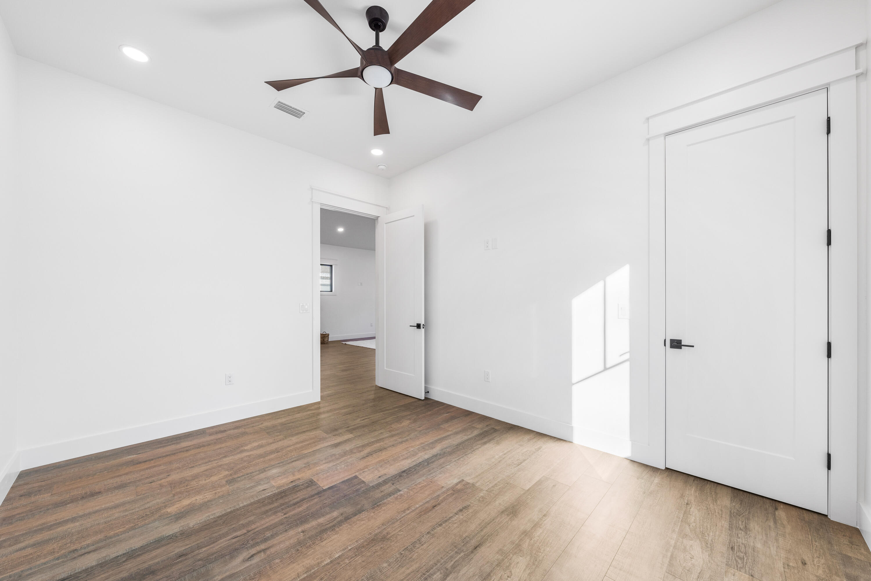 783 Indian Woman Road Santa Rosa Beach, FL 32459 - Photo 25 of 33 an empty room with wooden floor and a ceiling fan