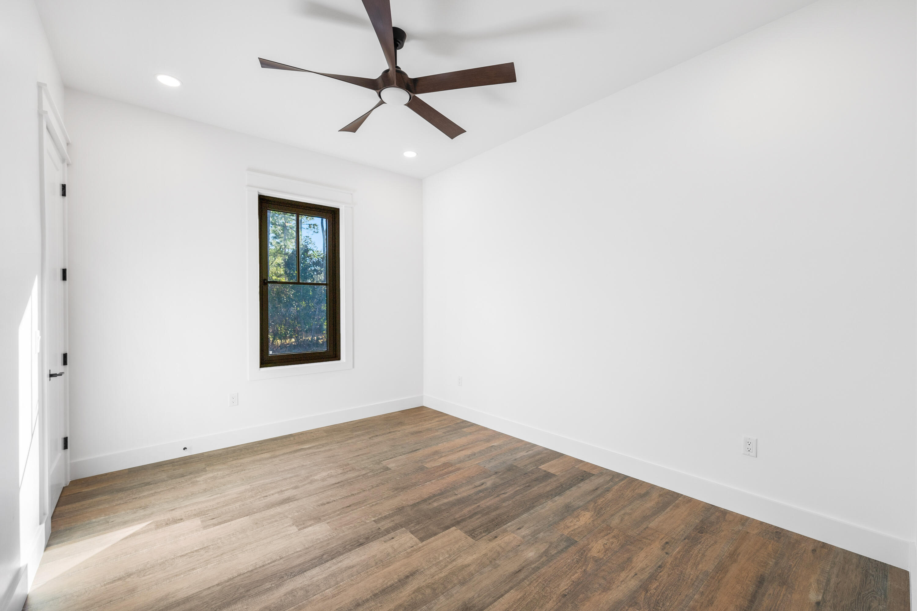 783 Indian Woman Road Santa Rosa Beach, FL 32459 - Photo 29 of 33 wooden floor in an empty room with a window
