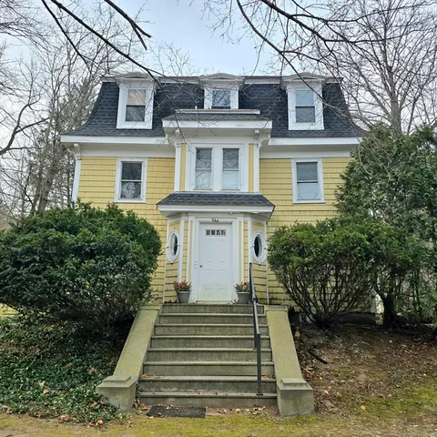a front view of a house with a yard