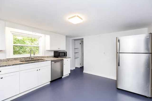 a kitchen with a refrigerator and a sink